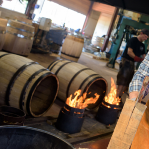 Oak wine barrels are being toasted
